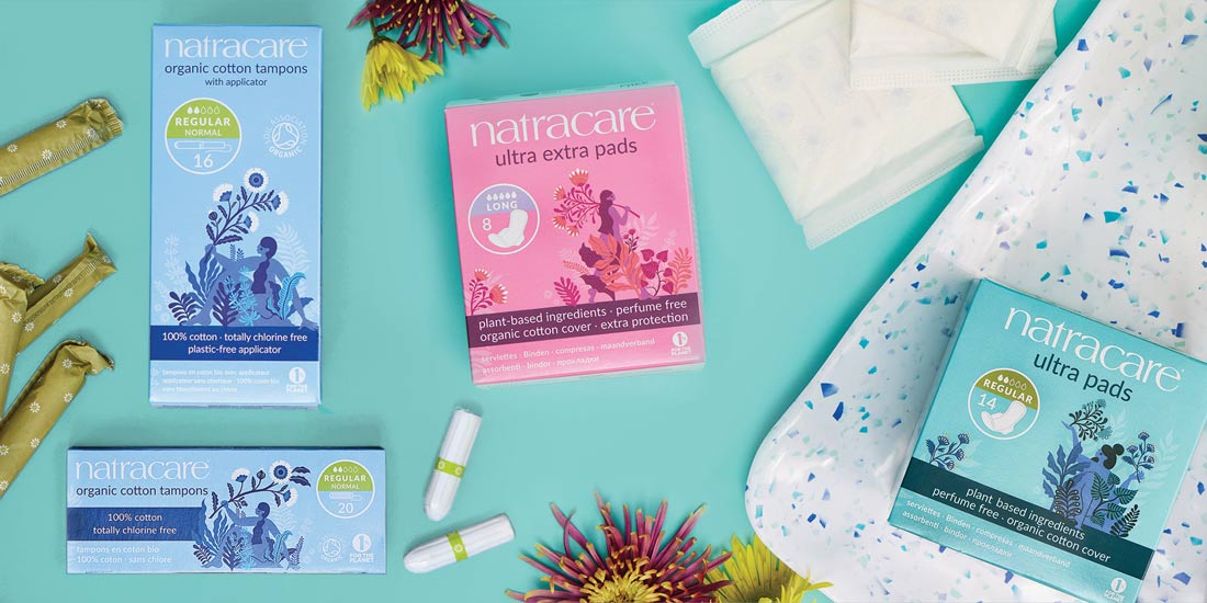 organic cotton tampons and ultra extra pads on a blue background